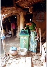 A woman in Nepal cleans water for her family using a filter developed by MIT researchers.