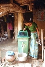 A woman in Nepal cleans water for her family using a filter developed by MIT researchers.