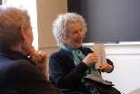 Novelist Margaret Atwood shows students one of the notebooks in which she does most of her writing. Atwood gave a lecture at MIT on April 4 and visited classes, including one taught by Rebecca Faery (left), director of first-year writing in the Program in Writing and Humanistic Studies.