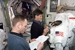 Astronaut and MIT alumnus Mike Fincke (left) looks over a procedures checklist during a training session for his International Space Station mission with cosmonaut Gennady I. Padalka (right).