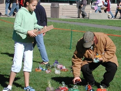 Shoppers browse the MIT Glass Lab's glass pumpkin patch.