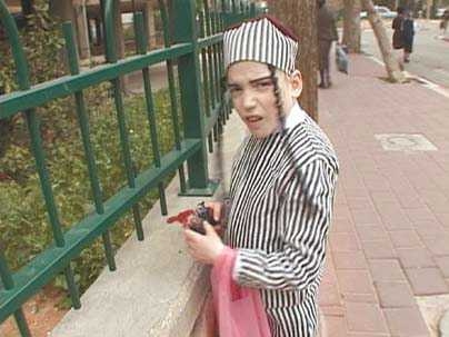 A still from the film "When Adar Enters" by Yael Bartana shows a young boy celebrating Purim.