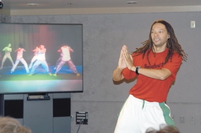 Professor Thomas DeFrantz follows moves by a group of dancers in Singapore in a video conference dance class sponsored by the MIT-Singapore Alliance.
