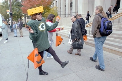 Community Giving volunteer Joan Nelson of Facilities greeted passersby at 77 Massachusetts Ave. wearing her Green Bay Packers costume.