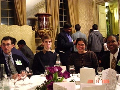 From left, MIT juniors Benjamin Schwartz and Sean Markan, alumna Natalia Toro, and sophomore Chintan Hossain enjoy themselves during a banquet at the Physics for Tomorrow conference held in Paris.