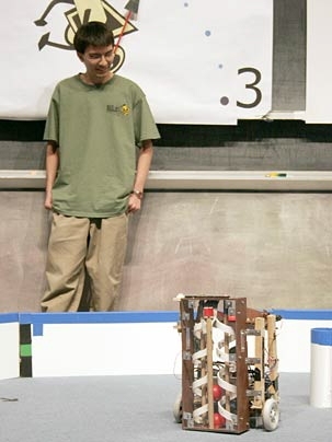Andrew Spann watches his team's robot, Archimedes Pi, compete in IAP Maslab.
