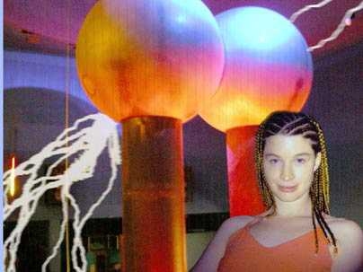 "Zap!" composer Christine Southworth (S.B. 2002) poses with the Van de Graaff generator that provides static and flashing lights for her musical composition. "Zap!" is a seven-part piece featuring the former atom-smasher in concert with flutes, guitar, cello, bass, piano, robots and human voices.