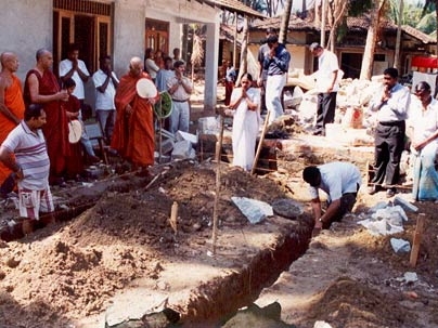 Buddhist monks pray as construction begins of single family houses for tsunami victims.