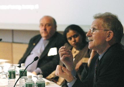 MIT Professor John Heywood, director of the Sloan Automotive Laboratory, far right, makes a point at the Alliance for Global Sustainability gathering on March 21 while panel members Leena Srivastava, executive director of The Energy and Resources Institute, India, and Professor David Marks, director of MIT's Laboratory for Energy and the Environment, look on.