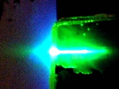A sensor film made of a novel semiconducting organic polymer undergoes a lasing process when exposed to ultraviolet light. When TNT is present, it binds to the polymer and quenches the beam.