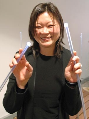 Assistant Professor J. Meejin Yoon of architecture shows off some of the light rods that will be in her exhibit, 'White Noise/White Light,' which opens on Kresge Oval Monday.