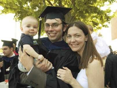 Ryan Eustice, center, celebrates receiving his Ph.D. hood with his son, Noah, 9 months, and his wife, Karen.