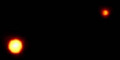 A Hubble view of the "Double Planet" Pluto and Charon. Pluto is to the left and Charon to the right.