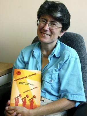 Elizabeth Wood, associate professor of history, holds up her new book, 'Performing Justice: Agitation Trials in Early Soviet Russia.'