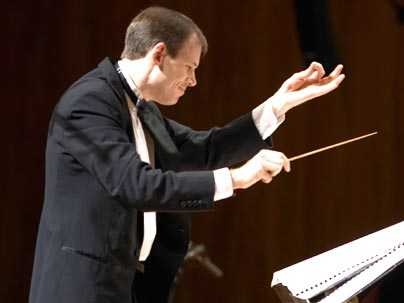 Fred Harris conducts the MIT Wind Ensemble. MIT President Susan Hockfield will perform with the ensemble on Oct. 14.