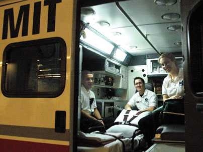 A new ambulance bay and ready room in the loading dock and basement of the Stata Center were dedicated Oct. 19. Nicolas Wyhs (S.B. 2005), left, and undergraduates Rachel Williams and William Baker are three of the students who run the service.