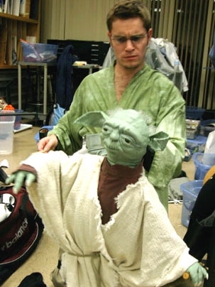 Kenneth Kamrin, a graduate student in mathematics, works with the Yoda puppet, one of the stars of 'Star Wars Trilogy: Musical Edition,' a production of the MIT Theater Guild.