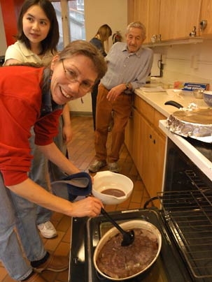 Associate Professor Anne McCants of history bastes the roast pork for her IAP session 'Old Food: Ancient and Medieval Cooking,' held Wednesday, Jan. 11, in the kitchen of Next House.