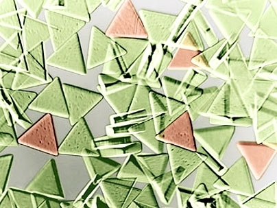 These triangular microparticles created at MIT are 100 microns on each side.