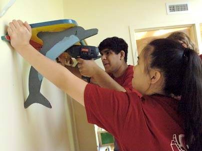 Freshman Geoffrey Thomas of Louisiana mounts a shelf at a local preschool along with fellow freshman Justine Li (right) of Baltimore, Md., during the City Days volunteer effort.