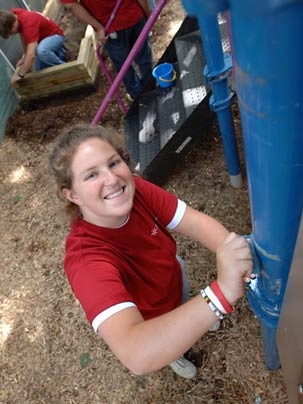 Freshman Tish Scolnik of Katonah, N.Y., scrubs a jungle gym as part of the City Days playground clean-up effort at the Cambridgeport Children's Center in Cambridge.