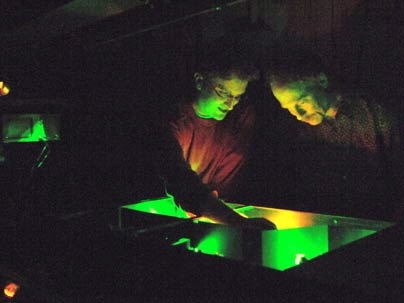 Peter Poulin, left, a former graduate student in the lab of Professor Keith Nelson, right, helps to set up a laser to observe light-induced changes in materials.