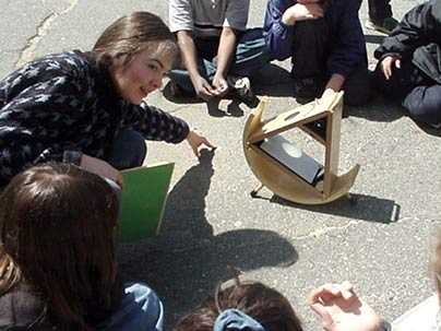Irene Porro demonstrates how to use a 'sunspotter' to safely show the sun and sun spots on it to a group of Somerville schoolchildren in 2001. Porro, education and public outreach scientist at the MIT Kavli Institute, has recently helped secure a grant to develop a youth astronomy apprenticeship program at MIT.