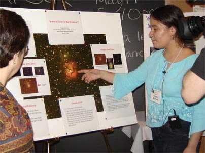 Angela Martinez of the John D. O'Bryant School of Math and Science answers questions about her project, "Is There Color in the Universe?" during the MIT Kavli Institute's annual "Astronomy in the City" event last May. A new grant will expand the Kavli Institute outreach program to include youth astronomy apprentices.