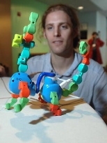 Hayes Raffle, a grad student at the Media Lab, demonstrates an iCampus project -- a programmable moose. Twisting its extremities generates both action and 'learning.'