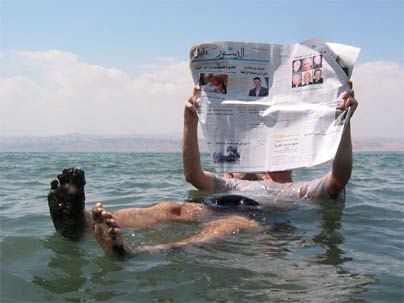 Man floating in the Dead Sea, Israel.