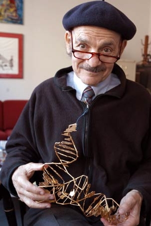 Biophysicist Alexander Rich first mixed two differing strands of RNA in 1956 to discover the RNA double helix. He holds a model of tRNA (transfer ribonucleic acid).