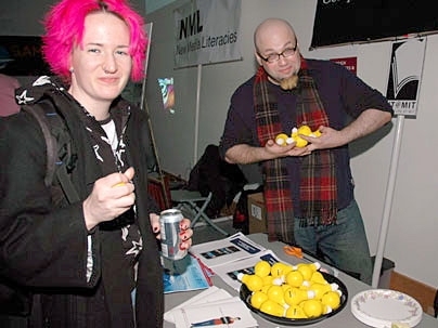 Generoso Fierro, CMS undergraduate administrator, offered 'stress bulbs' stamped with 'Comparative Media Studies' to visiting CMS student Cabell Gathman.