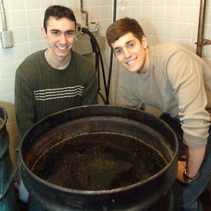 Chemical engineering junior Joe Roy-Mayhew, left, and mechanical engineering senior Matthew Zedler offer up a vat of used cooking oil for use as biodiesel fuel.