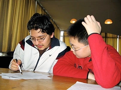 STEM program mentor Ernest Alba, left, studies with mentee Kevin Liang.