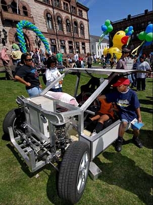 Harriette Crawford, left, Venola Bynoe, and Harriette's son Malik Crawford check out an intriguing vechicle in front of Cambridge City Hall.
