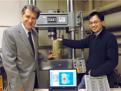 Professor Oral Buyukozturk of civil and environmental engineering, left, and student Tzu-Yang Yu in the lab with a concrete sample and an image (on the laptop screen) produced with the noninvasive damage-assessing technology they developed.