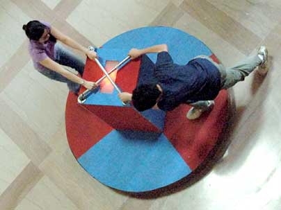 Jennifer Tang and Wesley Koo, sophomores in civil and environmental engineering, provide human power to make their merry-go-round light up in lobby 7 on May 10.