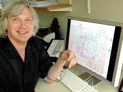 Douglas Lauffenburger, director of Biological Engineering, with a schematic of the intracellular "information-processing" circuit on the monitor in front of him.