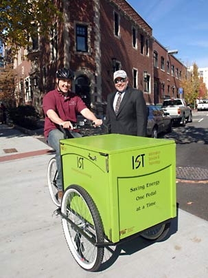 Ryan Flanagan, left, and vice president  Jerry Grochow of MIT's Information Services and Technology pose at the ready with the department's new 'green' cargo tricycle.