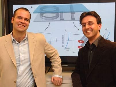 Postdocs Peter Rakich, left, and Milos Popovic of MIT's Research Laboratory of Electronics stand in front of a monitor that shows a demonstration of the way they propose to control microchips with light.