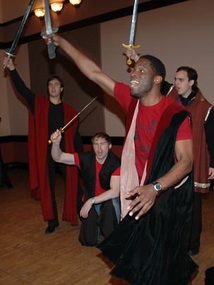 Taariq Lewis, in front, gives enthusiastic voice to Shakespeare's 'Henry V' along with, from left, Robin Lamb, Ben Frenkel and Ignacio Diaz. All are MIT Sloan students.