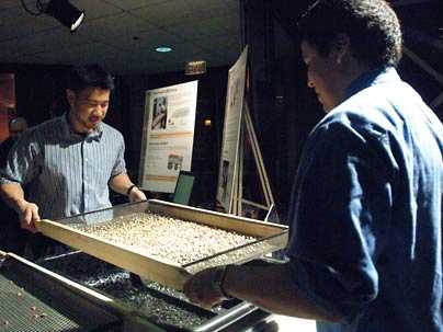 MIT seniors Jonathan Hsieh, left, and J.P. Mendieta of mechanical engineering demonstrate their coffee bean sorter prior to the presentation day for their class 2.009 Product Engineering Processes.