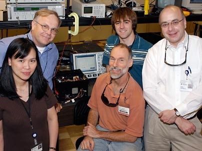 Lexington High School physics teacher Mark Zagaeski, shown seated, is surrounded, from left, by Lincoln Laboratory scientists Xuan Eapen, Tom Jeys, Simon Hutchinson and Greg Cappiello.