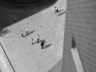 The same scene from above is shown from a dehumanizing gaze of surveillance cameras.