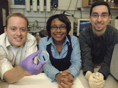 From left, Broad Institute postdoctoral associate Kris Wood, Bayer Professor of Chemical Engineering Paula Hammond and chemical engineering graduate student Dan Schmidt show the thin film they have developed. The film releases drugs and other chemical agents upon application of a small electrical field.