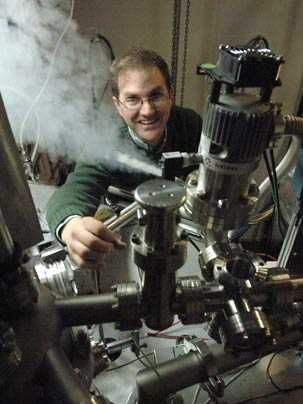 Assistant Professor of Physics Eric Hudson transfers liquid helium to cool the scanning tunneling microscope he is using in his research on high-temperature superconductivity.