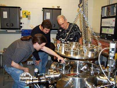 Graduate students Dan Casey and Mario Manuel, left, and senior research scientist Richard Petrasso of the MIT Plasma Science and Fusion Center with the detector used to study implosions that recreate the high temperatures and densities found inside stars.