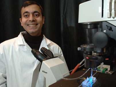 Professor Rohit Karnik works in the lab with the new method for cell separation that he, Institute Professor Robert Langer and other colleagues have developed. It involves steering rolling cells and could lead to devices for rapidly detecting diseases.