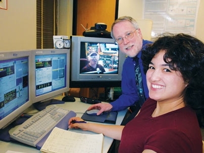 Earth, Atmospheric and Planetary Sciences Professor Richard Binzel, and graduate student Cristina Thomas, are doing remote observing of asteroids using a NASA IRTF telescope in Hawaii that they are controlling from MIT. They are assisted by Paul Sears (on TV screen), a research associate in Hawaii.