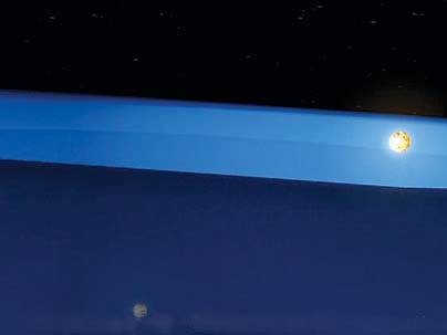 The unusual geometry of this star system made it possible for researchers to discover the first evidence of the middle stages of planet formation. Above, one star rises above the obscuring disk of matter, and its light becomes visible.